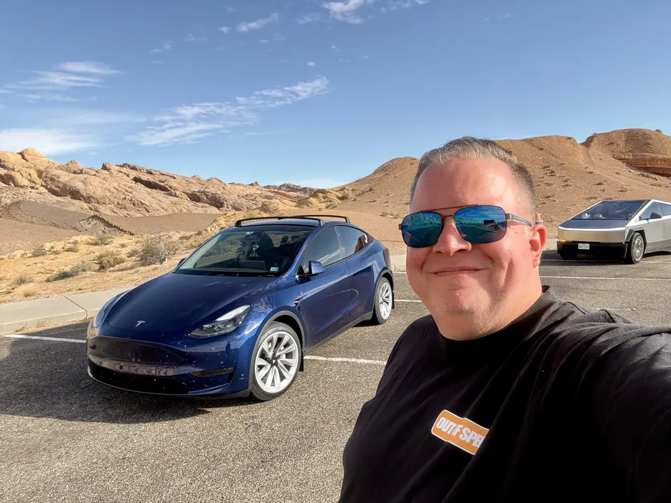 John with his blue Model Y during a desert road trip
